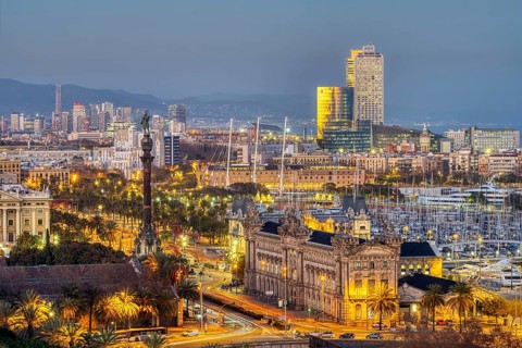 The Barcelona skyline with the Columbus statue at dusk