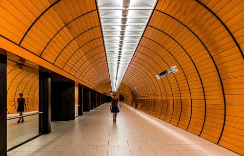 Munich, Bavaria, Germany, 07 29 2018: Young woman in summer skirt walking through a pedestrian