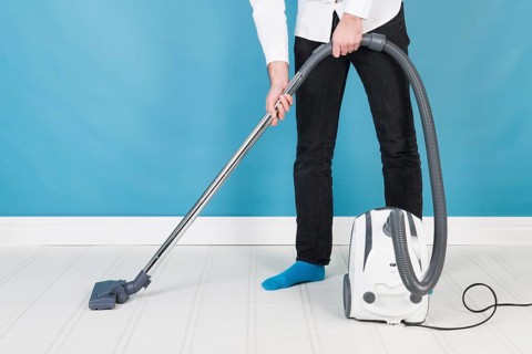 Man with vacuum cleaner cleaning the interior