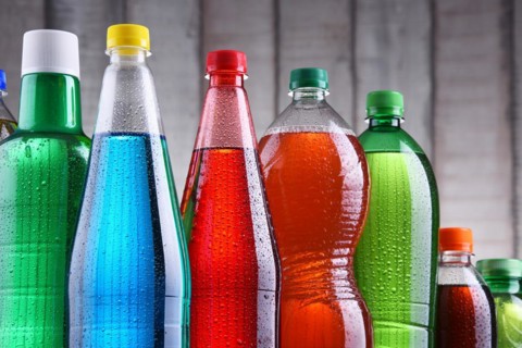 Plastic bottles of assorted carbonated soft drinks in variety of colors