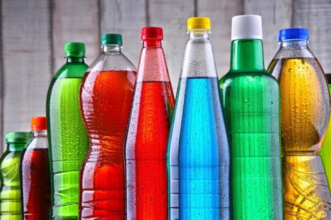 Plastic bottles of assorted carbonated soft drinks in variety of colors
