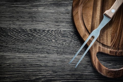 Meat fork Wooden cutting board on wooden background