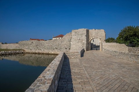 Skyline of a small Mediterranean town, historic city centre with massive city walls on an island in