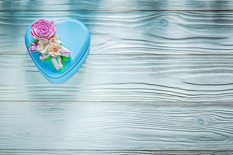 Present box on wooden board top view holidays concept