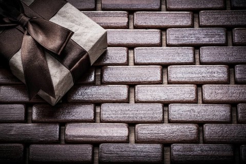 Packed giftbox on wooden wicker matting holidays concept