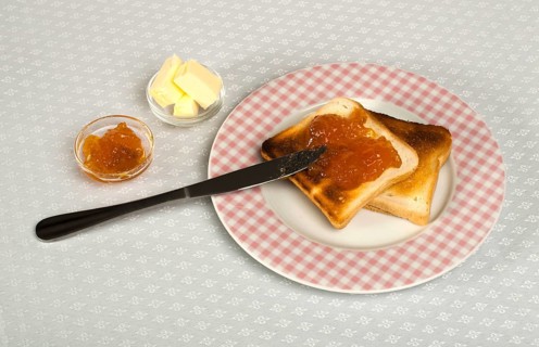 Spread jam on bread with knife