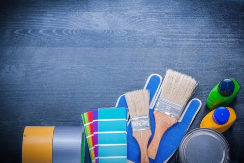 Set of painting tools on wooden board construction concept