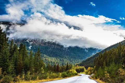 Canadian Rockies. Beautiful September day. Great Highway is among the mountains and forests