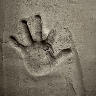 Hand print on cement mortar wall with shadow relief
