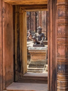 Kneeling guardians keep watch over the interior of the 'Citadel of the women', Banteay Srei,
