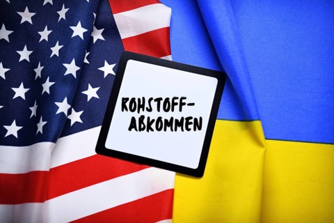 The flags of Ukraine and the USA with plaque and inscription Raw Materials Agreement, photomontage