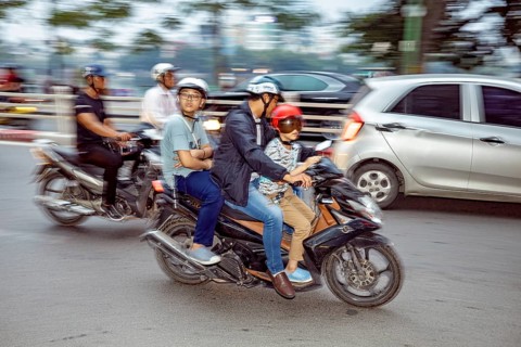 People riding motorbikes in city traffic, wearing helmets, blurred background, The crazy traffic of