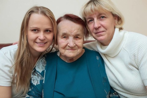 Family portrait of three generations. Mother, daughter and grandmother smiling