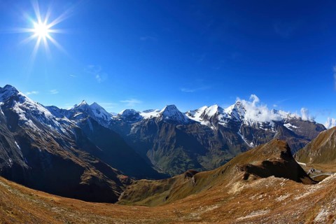 Austrian Alps. Great highway winds between hillsides yellowed. Excursion to the picturesque