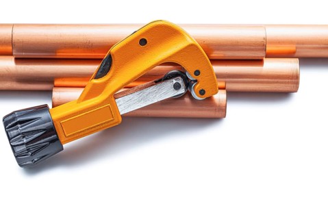 Pipecutter And Copper Pipe Isolated On White