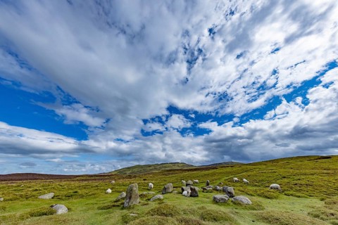 Druids Circle, stone circle in wide landscape with pastures in the mountains, Penmaenmawr,