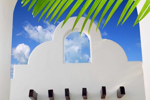 Mexican architecture white archs blue sky in Mayan Riviera