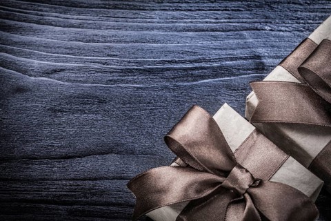 Wrapped gift boxes on wooden board holidays concept