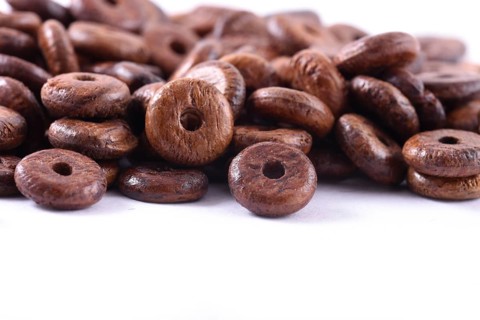 Wooden beads close-up on white background. Close up, macro