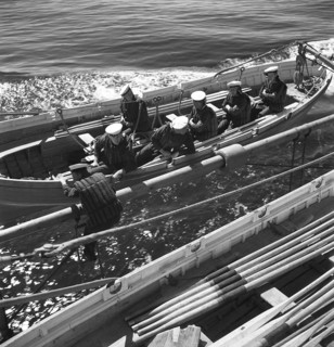 During World war II. The war ship Sverige during navy exercises at sea. The life boat is being