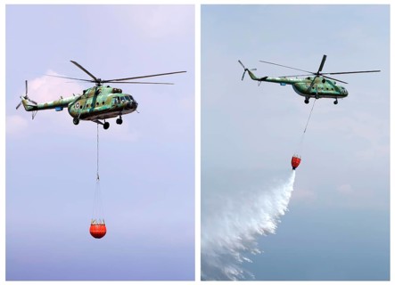 Helicopter extinguish fire with water tank