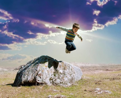 Jumping boy from big rock