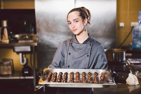 Subject profession and cooking pastry. young Caucasian woman with tattoo of pastry chef in kitchen