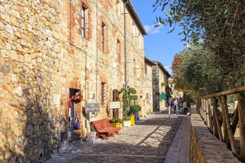 Tourists walk in Via I Maggio -Monteriggioni, Italy, Europe