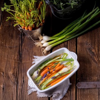 Young carrots and spring onions prepared for baking