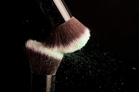 Cosmetics brush and colorful makeup powder