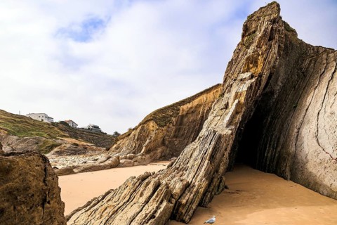 Adorable sea gull. Incredible rock formations, stones and boulders. Cantabria, Spain. The Playa de