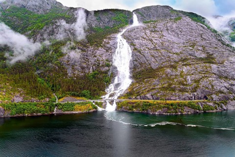 Langfossen cascade waterfall on the Vaule river. Western Norway. Passes through the highway. The