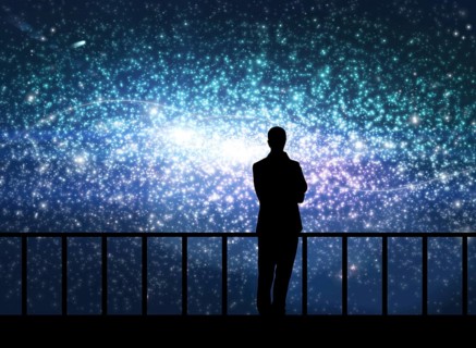 Silhouette of young man stands on the bridge in cosmos