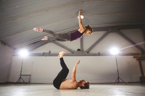The theme of Acroyoga and Yoga Poses. Acroyogis practicing. with studio Backlight. the Base man