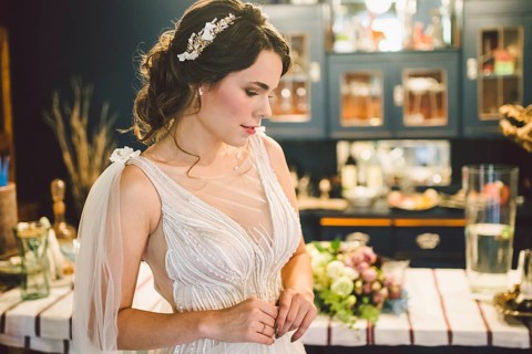 Bride in beautiful dress standing indoors interior at home. Trendy wedding style shot. Wedding