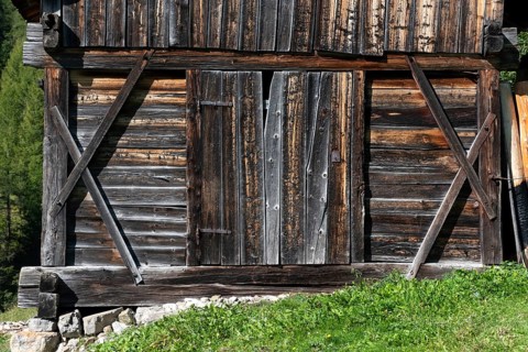An old wooden hay shed in Val di Morins, the Dolomite Alps of South Tirol