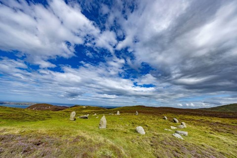 Druids Circle, stone circle in wide landscape with pastures in the mountains, Penmaenmawr,