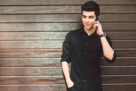 Portrait model young handsome male suspect Turkish middle eastern brunette in black shirt uses hand