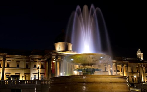 Illuminated Trafalgar Square with fountain and National Gallery, London, England London, England