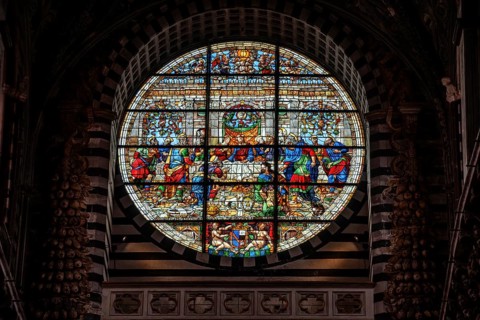 SIENA, ITALY, SEPTEMBER 23, 2023, Rich ornate window of the nave of the Siena Cathedral in Italy,