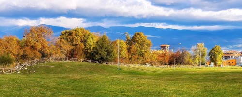 Bansko, Bulgaria autumn panorama banner background with colorful green, red and yellow trees, Rila