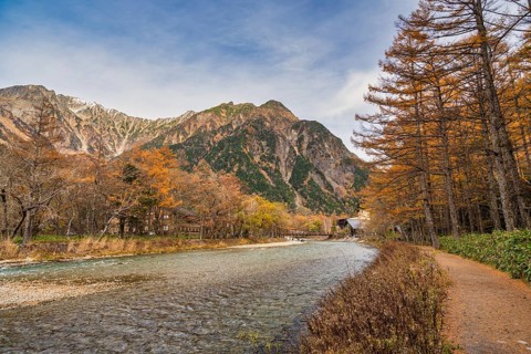 Nature landscape at Kamikochi Japan, autumn foliage season with pond and mountain