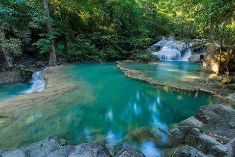 Erawan Waterfall with fish in water in Kanchanaburi Province, Thailand, Asia