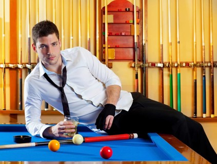Billiard handsome player man drinking some alcohol in club