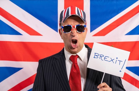 British male businessman with Brexit banner and UK flag