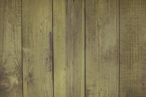 Green painted wooden boards creating a rustic background texture, ideal for design projects related