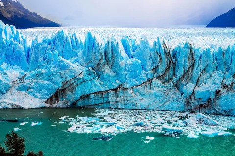 The colossal Glacier Perito Moreno in Patagonia on Lake Argentino. The cloudy sky covers the