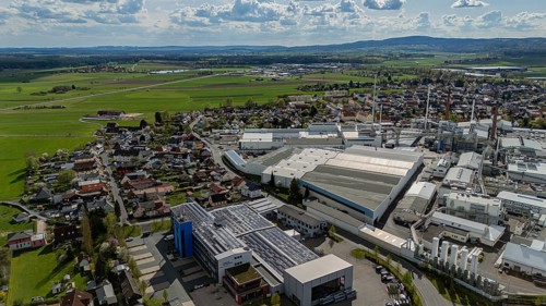 Industrial building scene next to a cityscape with a wide view of fields and sky, Mitterteich,