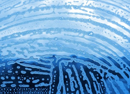 Soap foam bubbles on the glass
