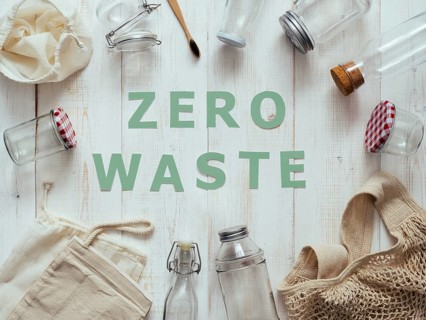 Zero waste concept. Textile eco bags, glass jars and bamboo toothbrush on white wooden background
